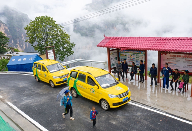 6月30日,两辆四川乡村客运面包车在阿布洛哈村等待乘客
